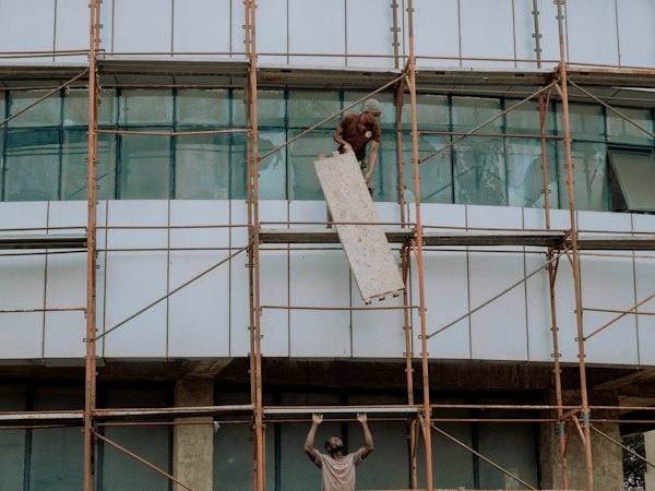 A builder working on scaffolding